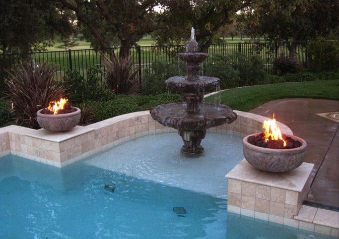 Fire bowls next to pool